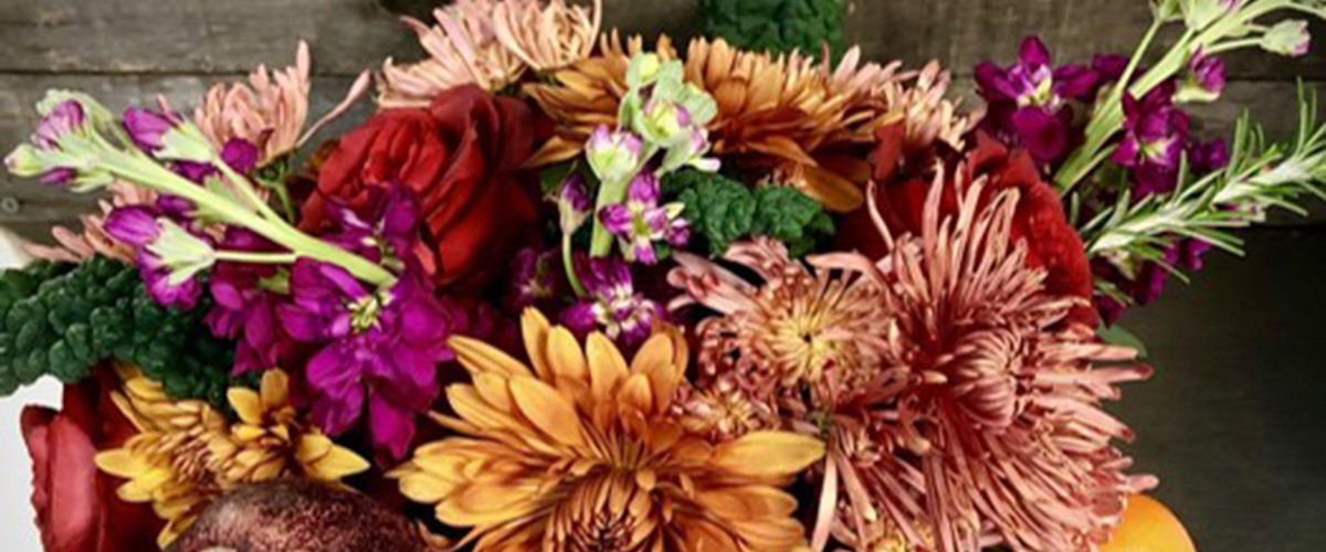 Detail of autumnal centerpiece including mums, stock and roses