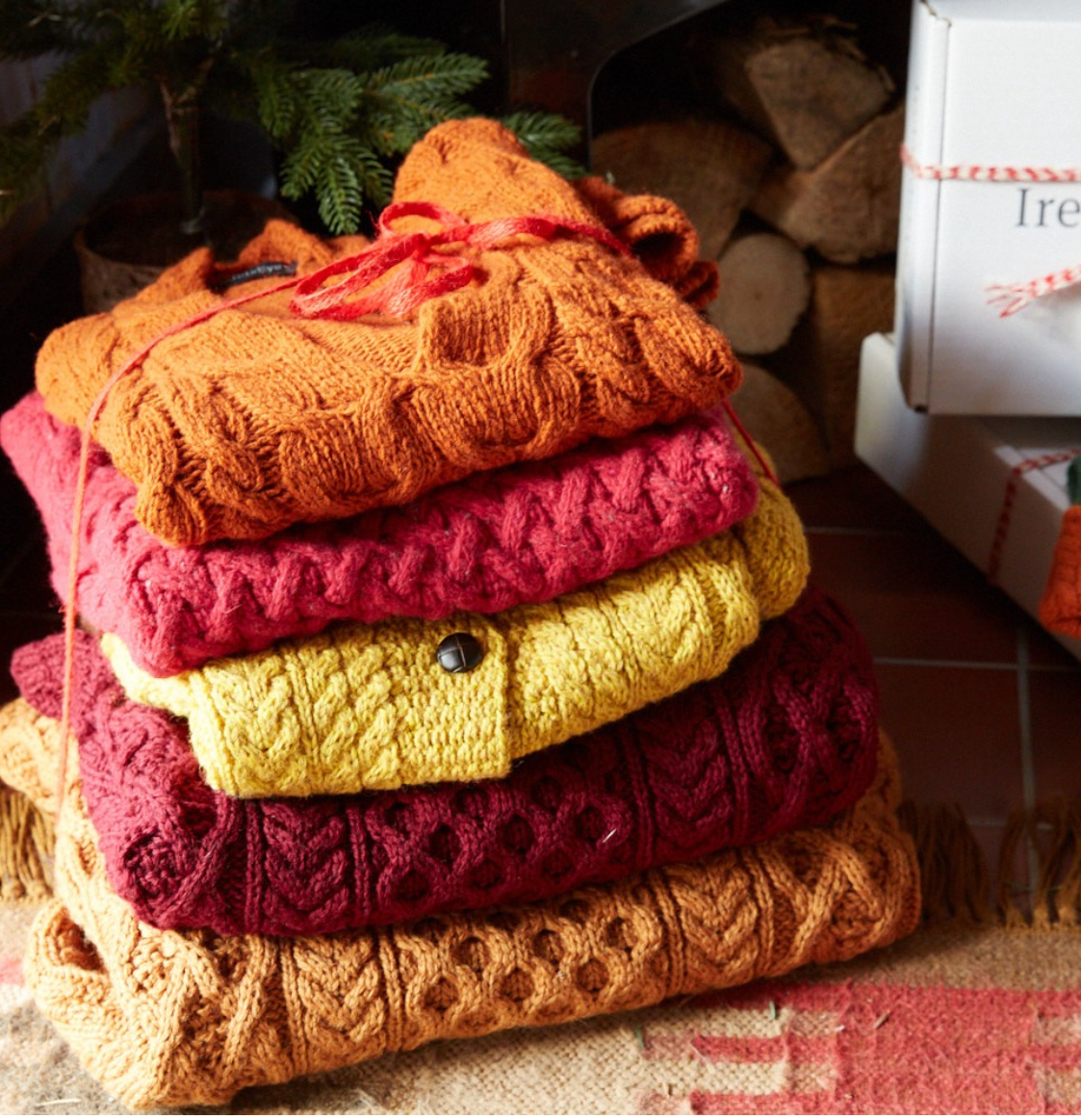 Stack of orange, red, and yellow knitwear