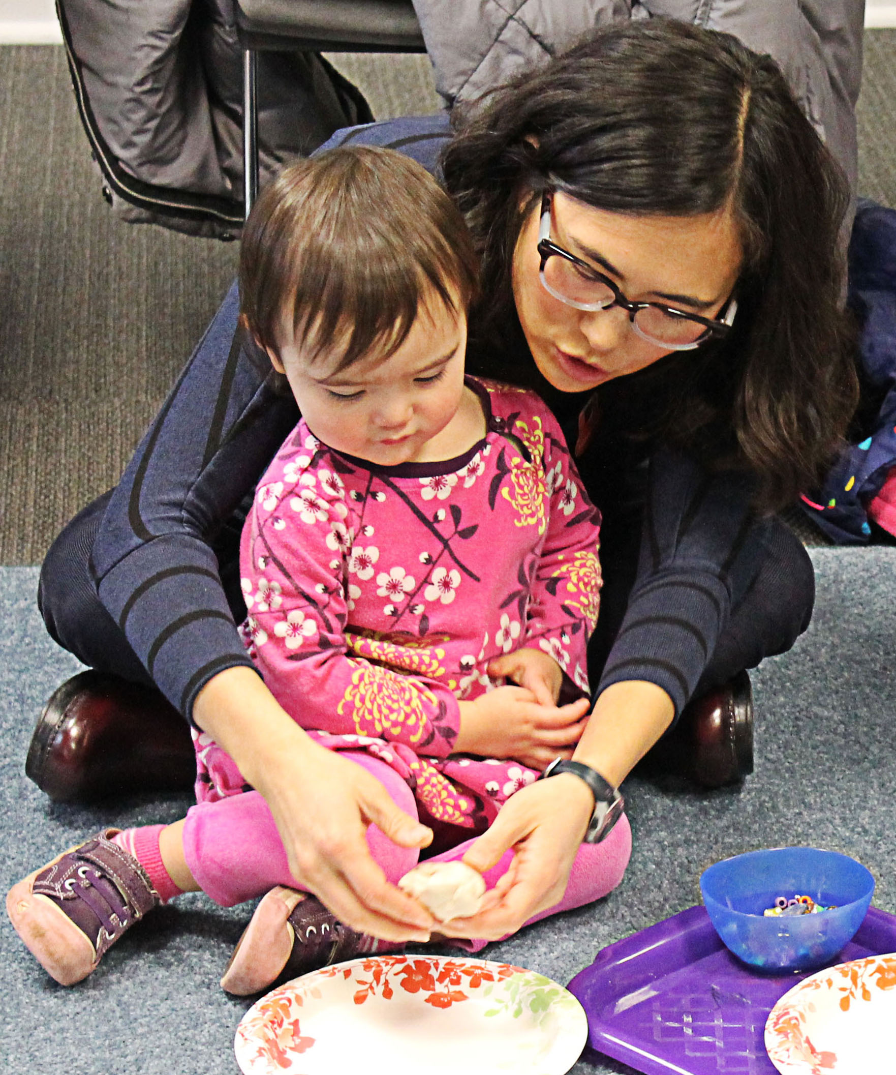 a preschooler and their grownup working on an art project together