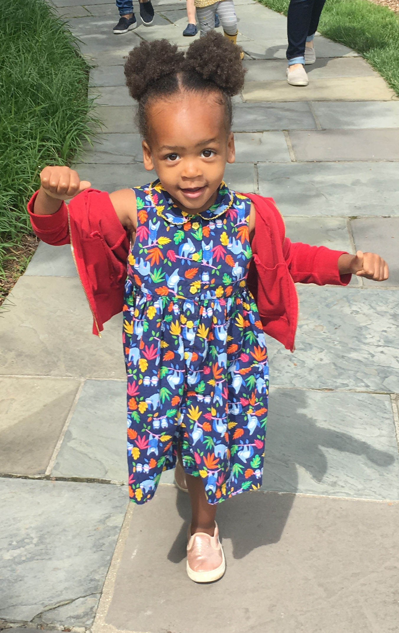 preschooler walking happily down a path through Hillwood's gardens