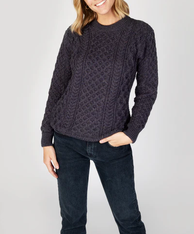 Woman wearing a dark purple sweater from IrelandsEye