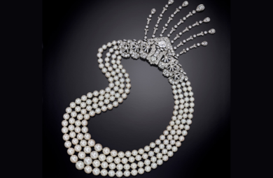 Image of a pearl necklace with diamond ornaments.