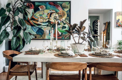 Image of a tablescape from Carter's book "Living Wild." It features houseplants as the main decorative feature of the table and room.